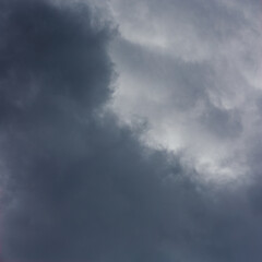 Dark stormy clouds fill the sky, creating a gloomy atmosphere. The overcast conditions suggest impending rain, highlighting the beauty of nature's power.