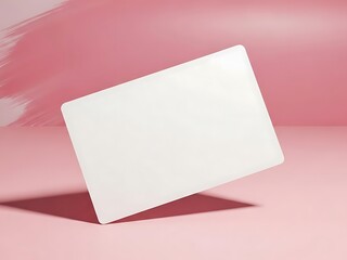 White rectangular card with rounded corners on pink background blank