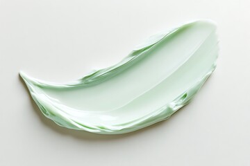 A smooth, light green cosmetic cream smear on a clean white background, showcasing its rich texture