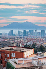 Naples cityscape with Mount Vesuvius in the background at sunrise. Capodimonte