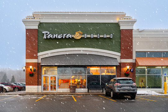New Hartford, NY - Dec 13, 2025: Panera Bread under heavy snowfall&mdash;with customers seeking warmth and food pleasure