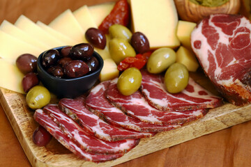 Italian food board. Ham, cheese, olives, ciabatta.