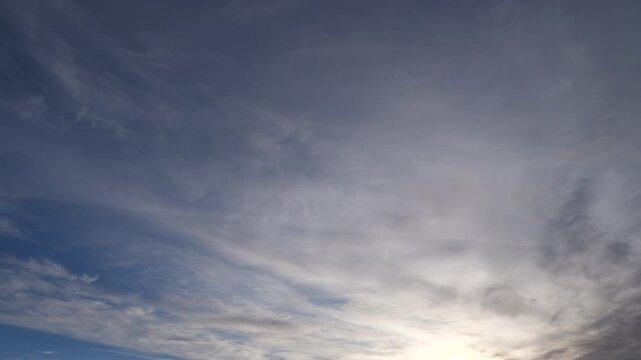 Morning sky with clouds and airliners passing by and leaving a long trail timelapse video