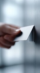Close-up of a hand holding a keycard or badge to tap into a corporate hub is flexible workspace access point, hybrid system.