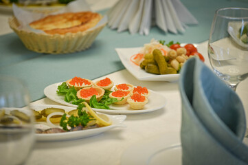 Red caviar tartlets on festive table 