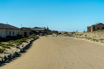 Kolmanskop abandoned ghost town in the Namib Desert, Namibia. Sand-filled interiors and decaying German colonial buildings illustrate nature reclaiming a once-thriving mining settlement