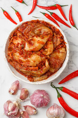 Kimchi is a dish of Korean cuisine made of cabbage and pickled (fermented) vegetables with red hot pepper and garlic. Close-up, selective focus