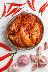 Kimchi is a dish of Korean cuisine made of cabbage and pickled (fermented) vegetables with red hot pepper and garlic. Close-up, selective focus