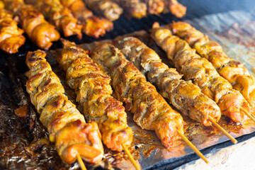 Cooked chicken skewers ready to eat at a food stand.