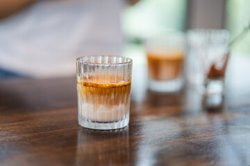side view of dirty coffee on wooden table at cafe