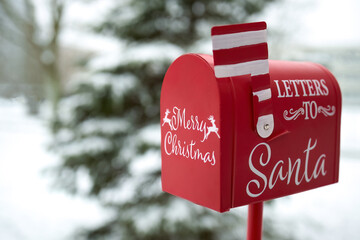 Santa's Mailbox in Snowy Scene. Red mailbox for letters to Santa, set in a snowy winter background