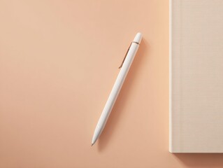 Minimalist flat lay with white pen and notebook on pastel peach surface