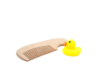 Yellow rubber duck  and Wooden hair comb isolated on white background. Children's bathing set.