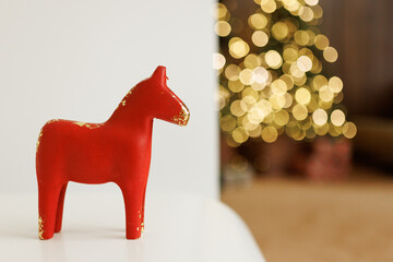 Red Scandinavian Christmas Horse with Festive Bokeh Lights