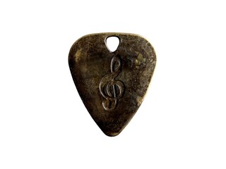 Metal guitar pick with treble clef engraving on transparent background
