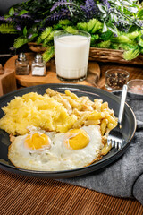 Fried eggs with boiled potatoes and yellow string beans.