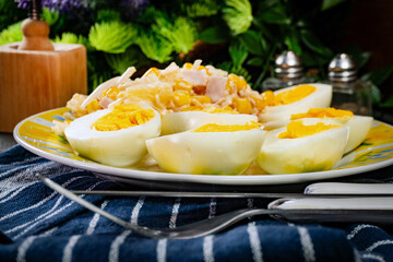 Breakfast. Hard-boiled eggs with ham, pineapple and corn salad.