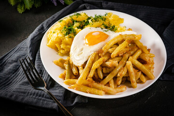 Fried eggs with boiled potatoes and yellow string beans.
