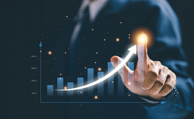 A hand touches a rising arrow graph on a digital interface, representing business success, financial growth, performance improvement, strategic progress, and positive market trends.