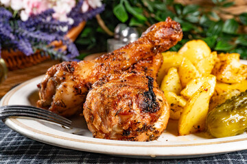 Baked chicken drumsticks with potatoes.