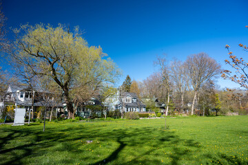 Suburban houses behind a green lawn in Toronto neighborhood