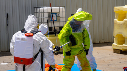 HAZMAT With Level A and Level C Suits Performing Decontamination