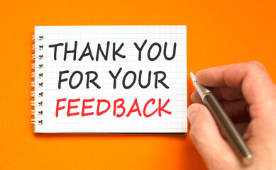 Thank you for your feedback symbol. Concept words Thank you for your feedback on beautiful white note. Beautiful orange paper background. Business thank you for your feedback concept. Copy space.
