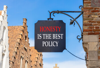 Honesty is the best policy symbol. Concept words Honesty is the best policy on black beautiful road sign. Beautiful blue sky background. Business honesty is the best policy concept. Copy space.