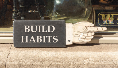 Build habits symbol. Concept word Build habits on beautiful black wooden hand with finger. Beautiful shop display background. Business build habits concept. Copy space.