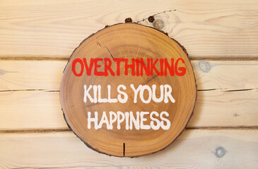 Overthinking kills your happiness symbol. Concept words Overthinking kills your happiness on wooden circle. Beautiful wooden wall background. Business overthinking kills happiness concept. Copy space.