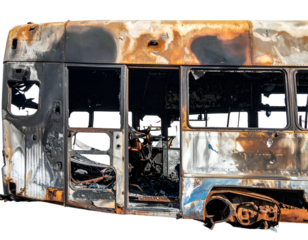 Charred vehicle interior, scorched seats, melted metal, destroyed bus
