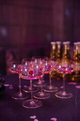 Celebration with elegant glasses of pink beverages and golden bottles at a festive gathering