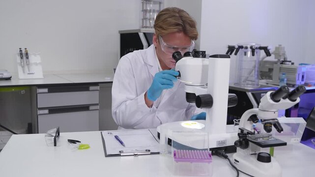 Research in a lab setting with a scientist examining samples through a microscope