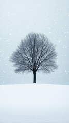 Fototapeta premium A single bare tree standing in the middle of a snow-covered field during gentle snowfall, against a soft pale blue winter sky.
