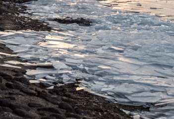 Layers of cracked ice on lakeside