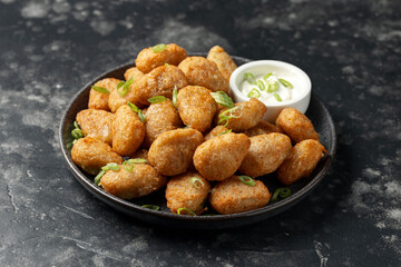 Crispy Jalapeno cheese bites with sauce. Party food snacks