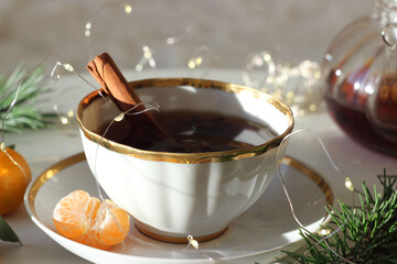 Black tea in a cup on a white table. New Year's decor.