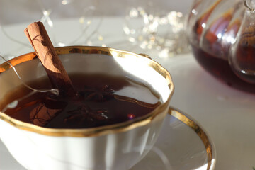 Black tea in a cup on a white table