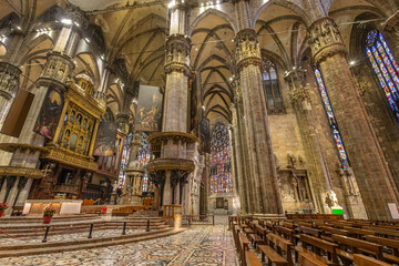 Fototapeta premium Grand Milan Gothic Cathedral Interior With Stained Glass, Altars, and Ornate Pulpit for Stock Image