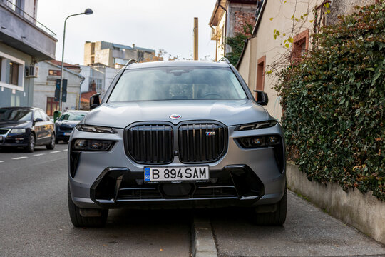 New grey BMW X7 M 60i parked on the street