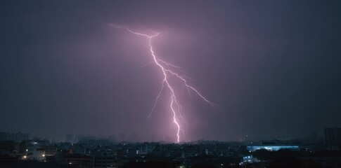 Dramatic Lightning Strike Illuminates Dark Night Sky Over Cityscape.