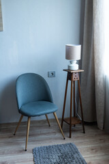 Minimalist armchair in modern living room interior with floor lamp