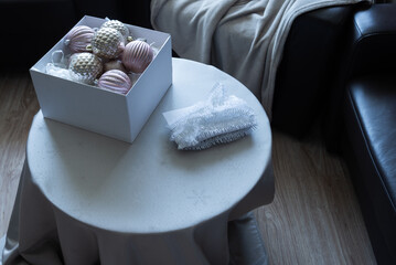 Christmas ornaments on table in modern neutral interior