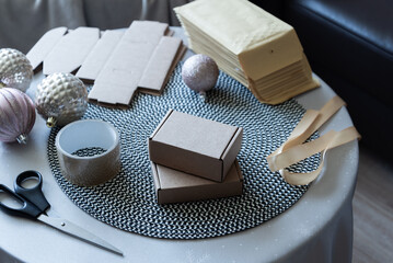Packaging boxes and shipping supplies on table in home workspace