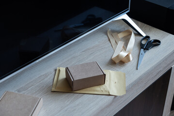 Cardboard box on padded envelope on home workspace table
