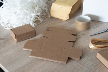 Cardboard packaging blanks and packing filler on work table