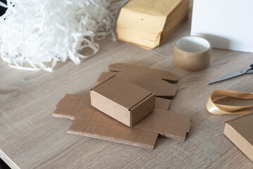 Small cardboard box with packing filler on work table