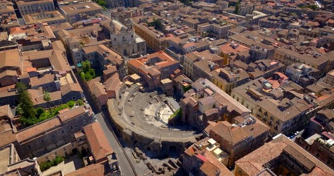 Aerial view of the Amphitheater of Catania, in Sicily, Italy. It's an ancient Roman amphitheater located in the historic center of city. In background is Saint Francis of Assisi all'Immacolata Church.