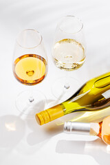 Obraz premium Different wine bottles and glasses on white background