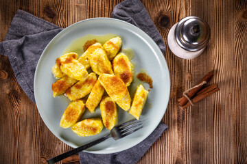 Homemade lazy noodles with cheese, crumbs and melted butter.